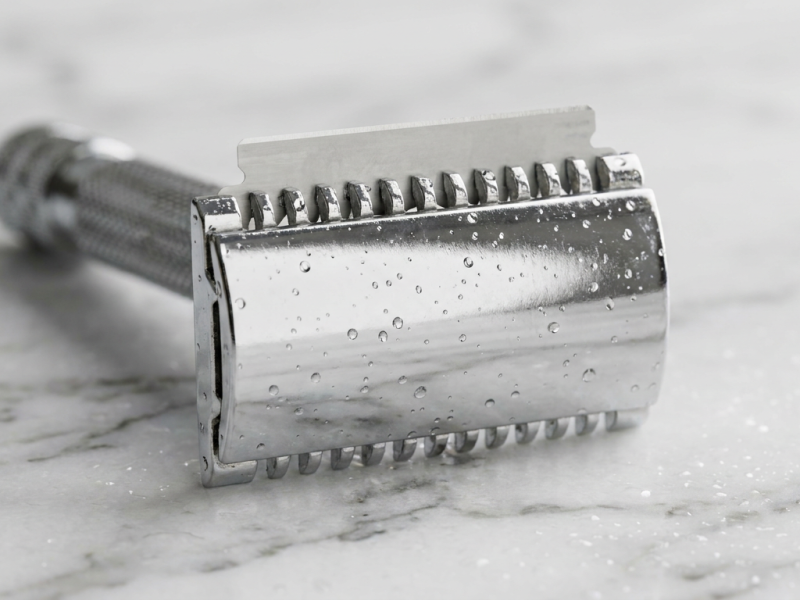 safety razor blade gap visible on a chrome double edge razor head close-up