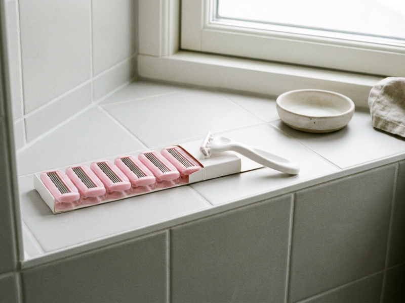Venus razor blade refills beside a white Venus handle