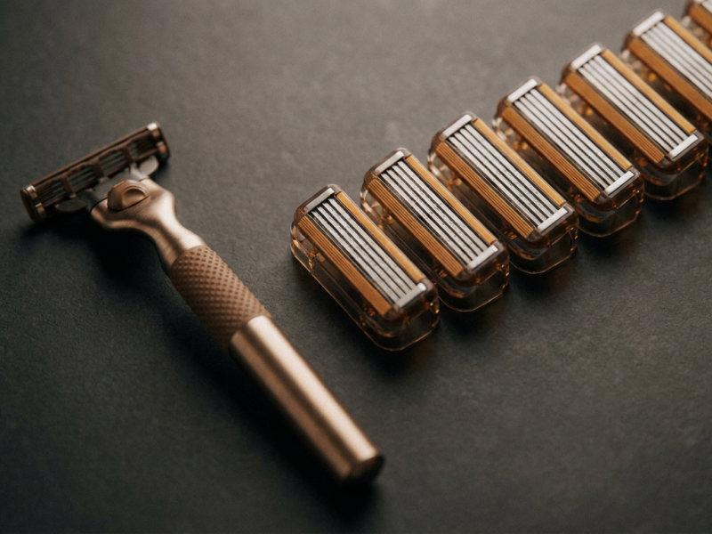 Razor handle and blade cartridges arranged on a countertop for a patriot shave razor overview